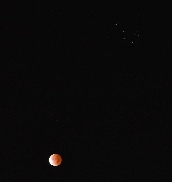 The moon near the pleiades constellation